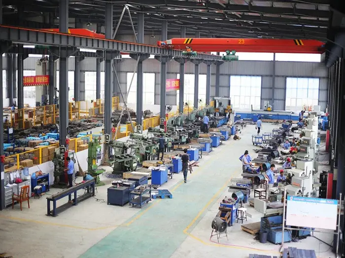 Workshop interior with rows of processing equipment and overhead cranes